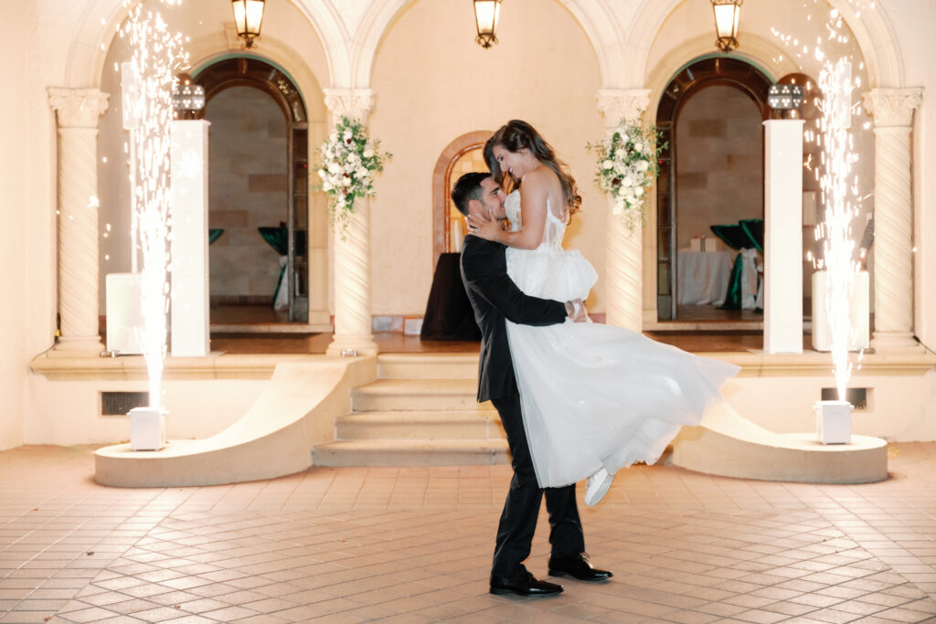 bride and groom dancing in front of sparklers