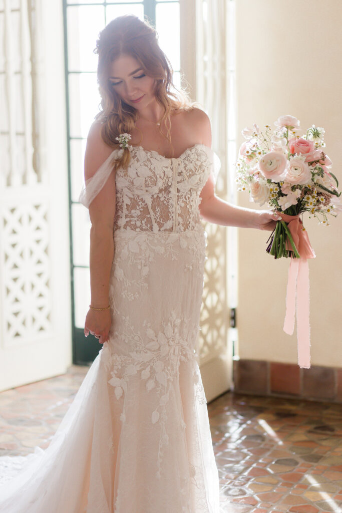 bride in elegant off shoulder lace gown 