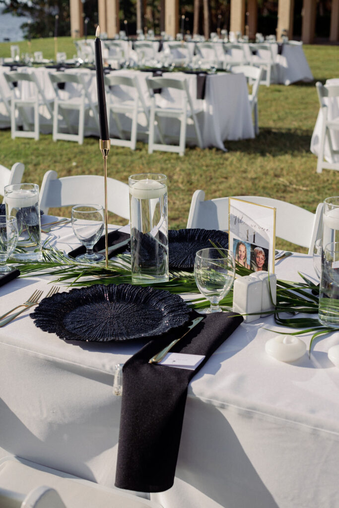 black wedding tablescape with greenery and candle centerpieces by Precious Moments Events