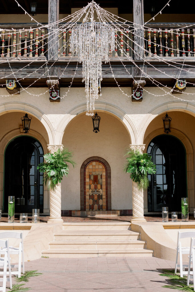 outdoor wedding ceremony decorated with palm leaves