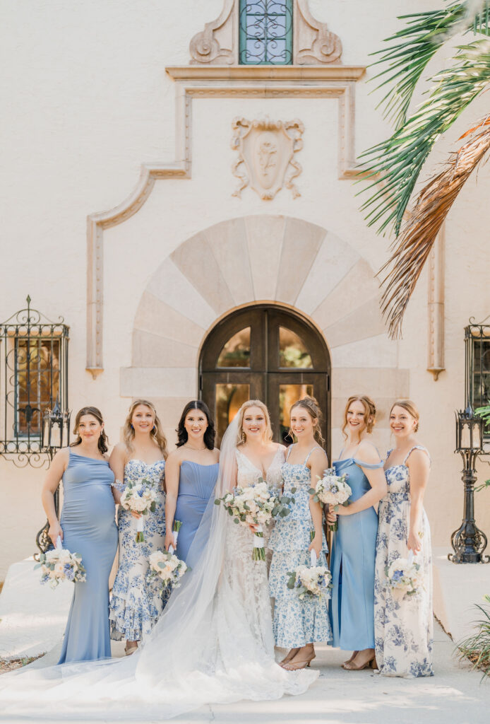 bridesmaids in dresses with different patterns and shades of blue