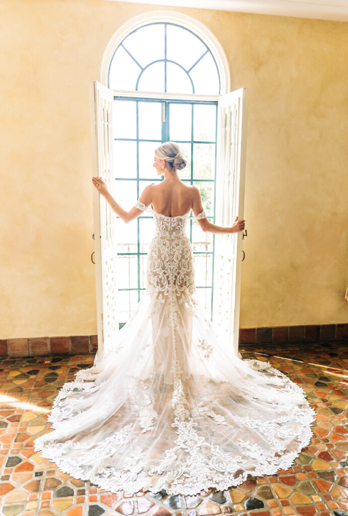 bride in fitted lace gown with lace train