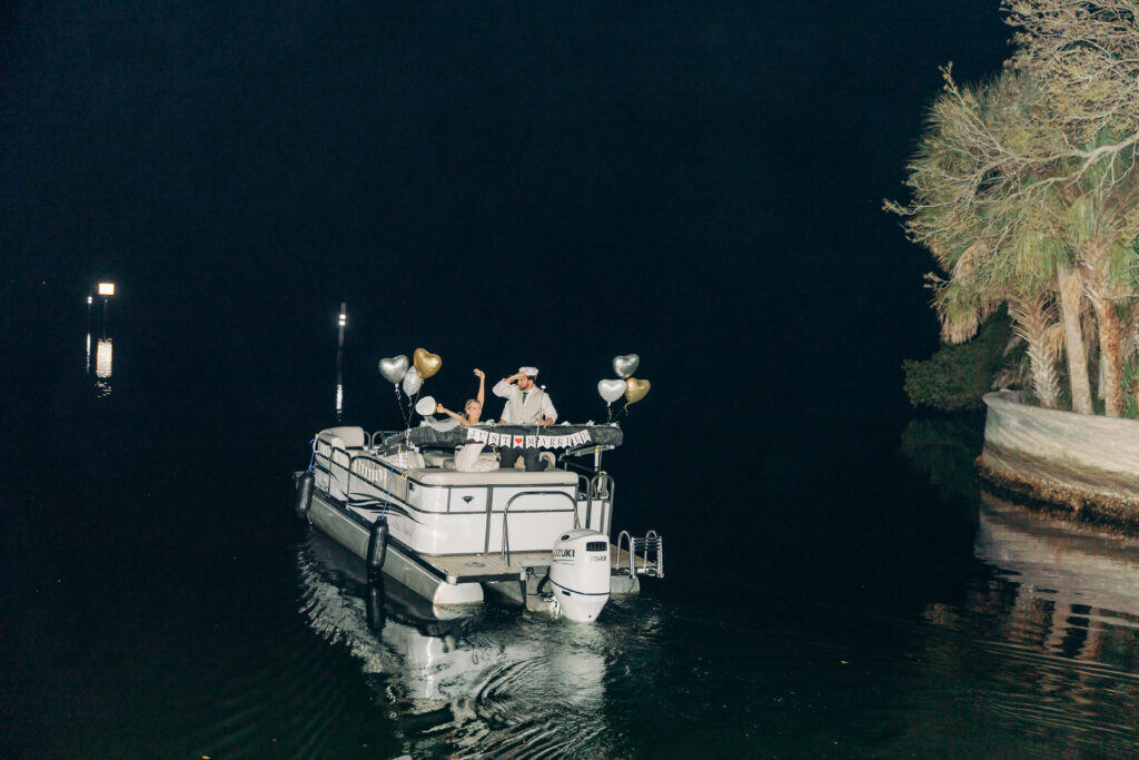 bride and groom exit via boat on Florida coast