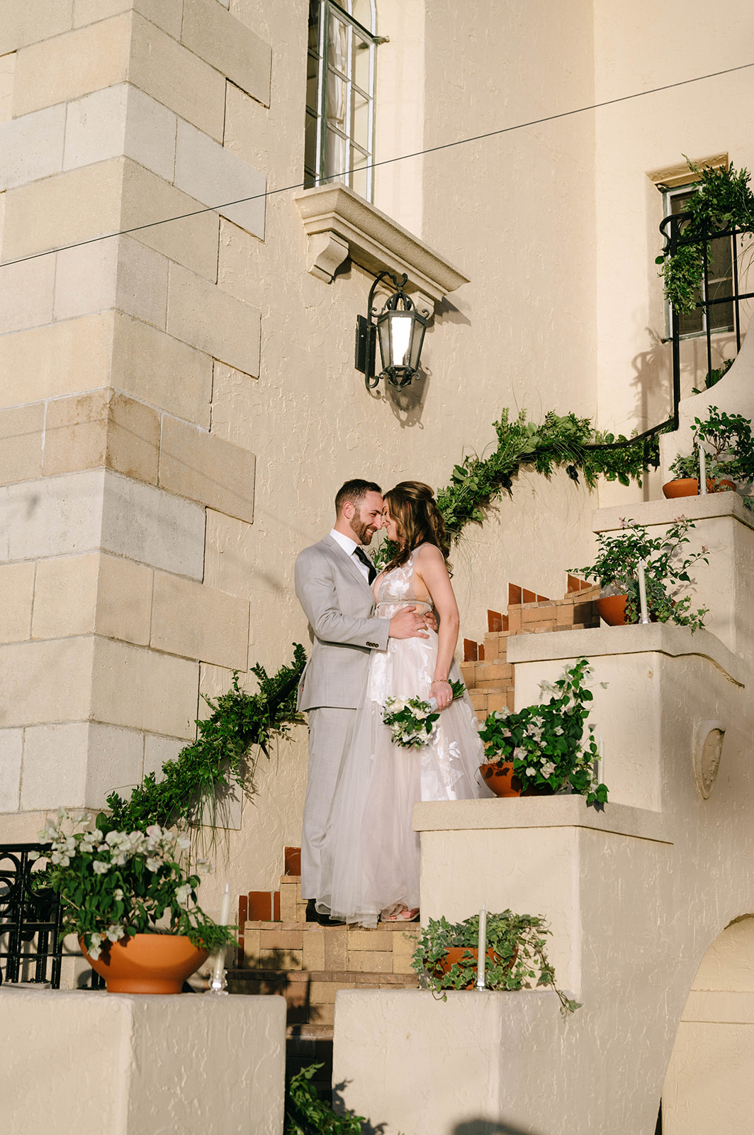 bride and groom on the steps at Powel Crosley Estate