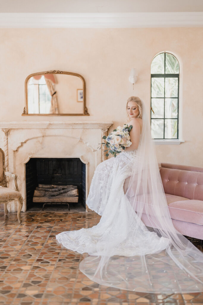 bride in classic lace gown and bouquet with roses and greenery