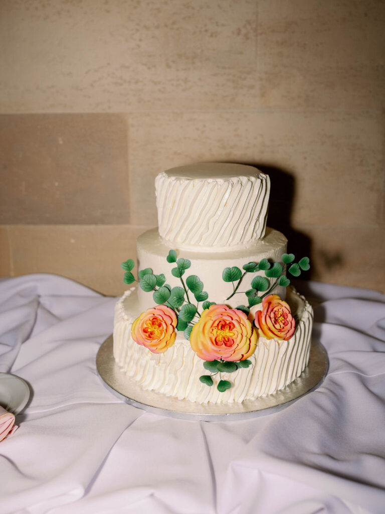 classic white wedding cake with colorful floral accents