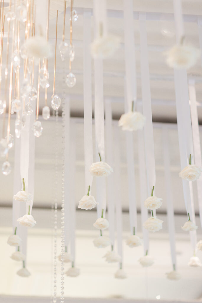 draped flowers and chandelier at indoor wedding