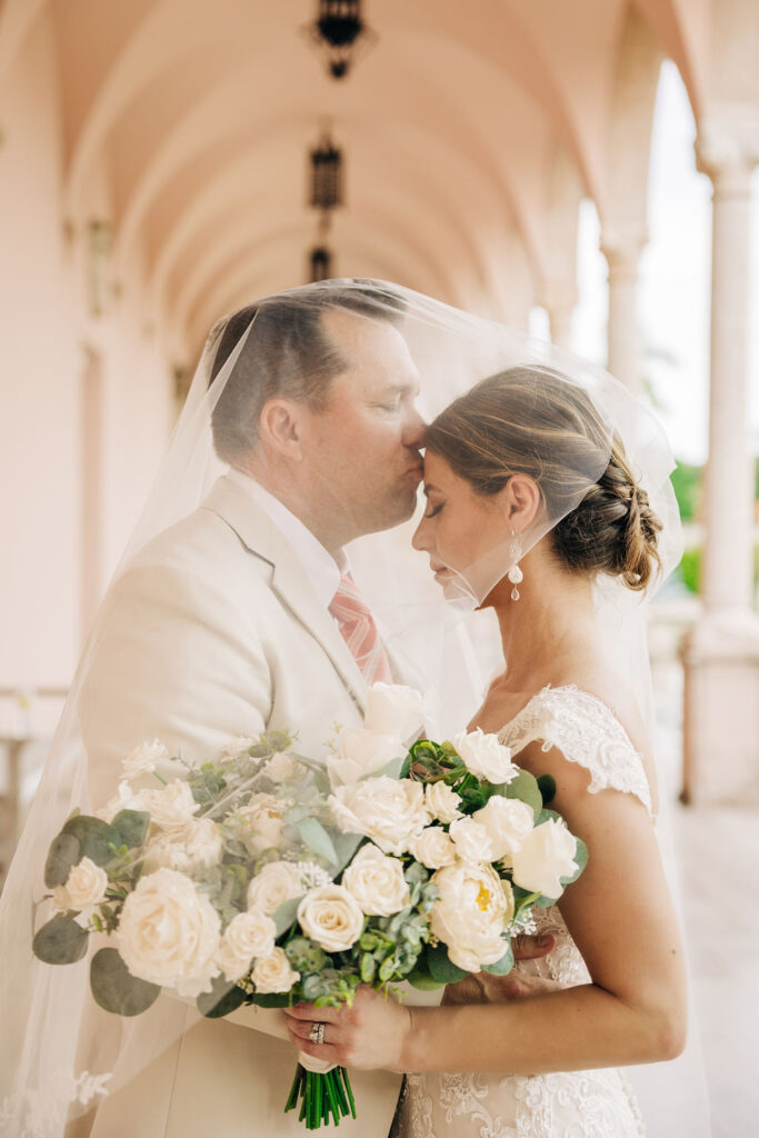 bride and groom portraits with wedding veil