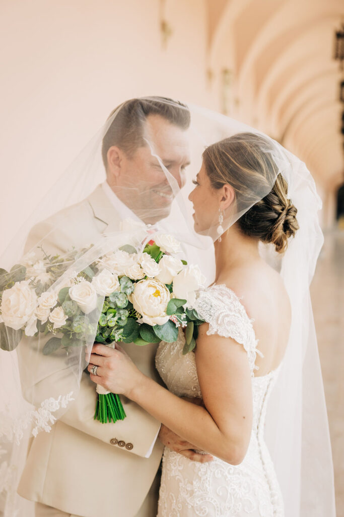 couple portraits with wedding veil