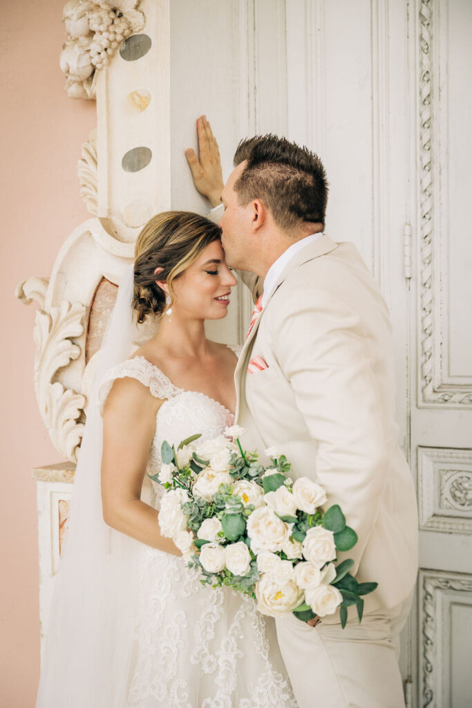 bride in lace lined gown and groom in tan suit