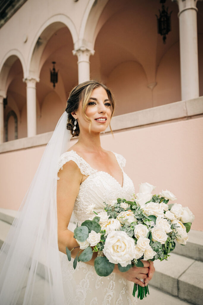 bride with large white floral bridal bouquet