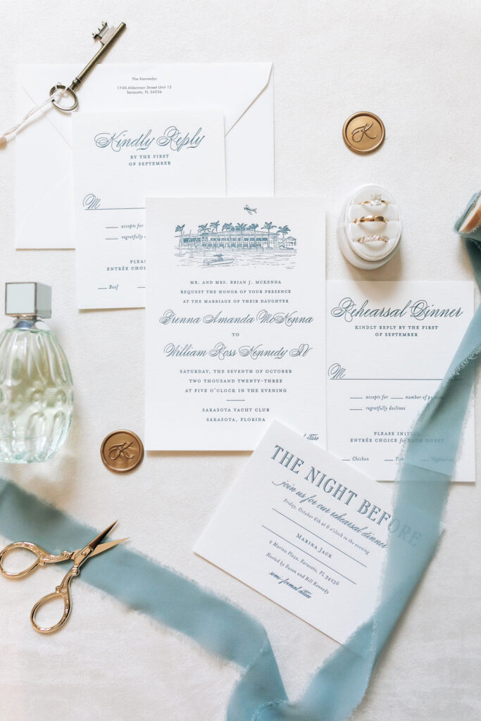 teal wedding invitation flatlay with custom artwork