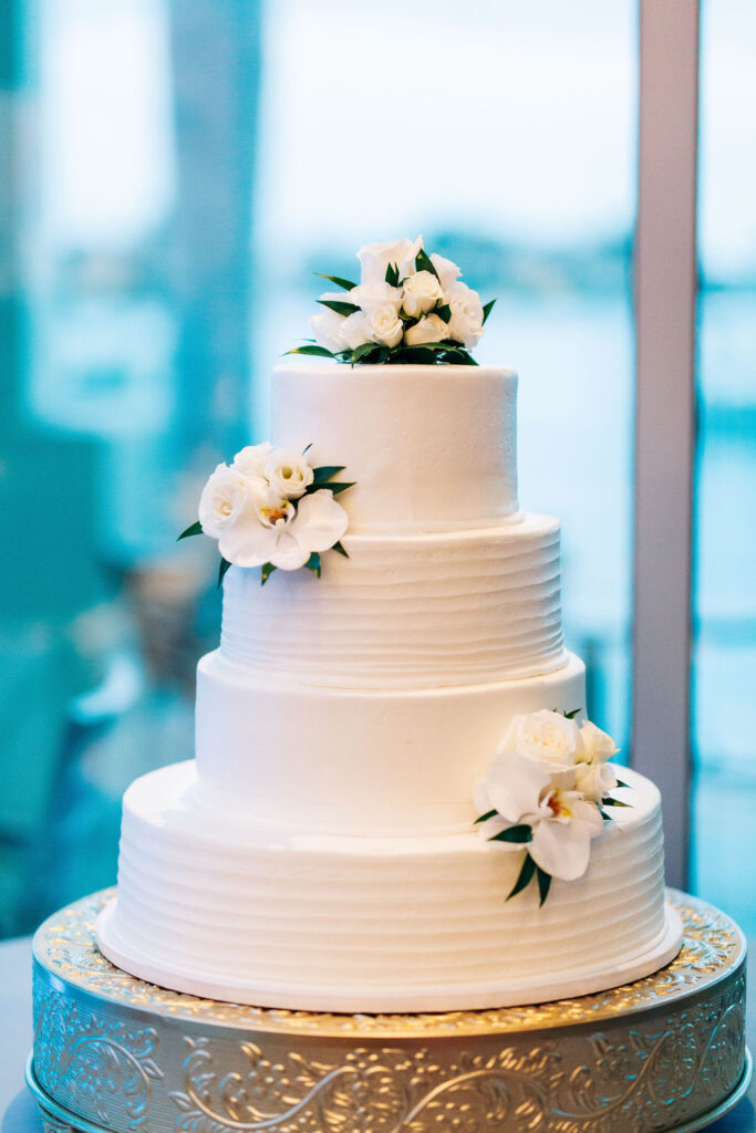 classic white wedding cake with floral accents