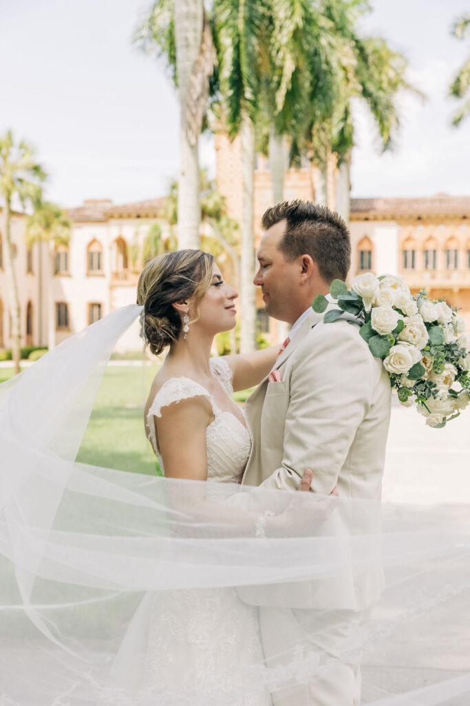 bride in classic lace gown and groom in tan suit