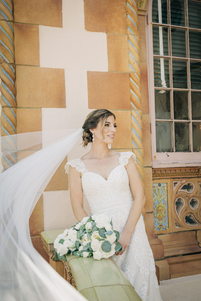 bride in lace and embroidered wedding gown with cathedral veil