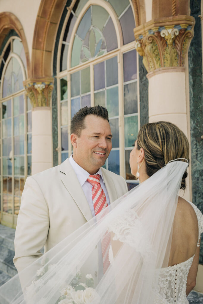 groom in tan suit with pink striped tie