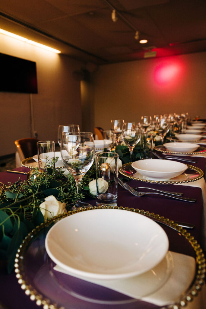 purple wedding tablespace with white roses and greenery