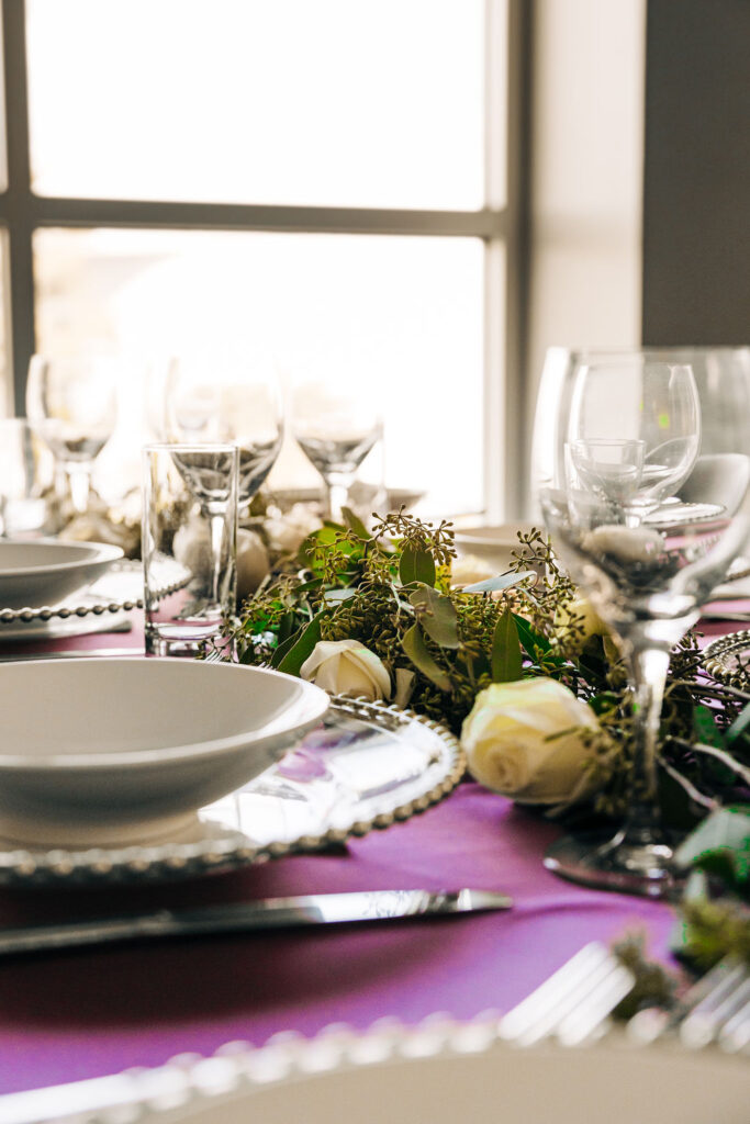 white roses and greenery wedding centerpiece