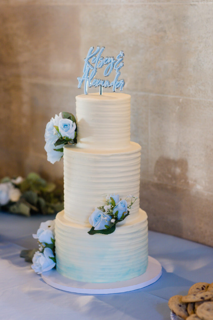 classic white wedding cake with blue flowers