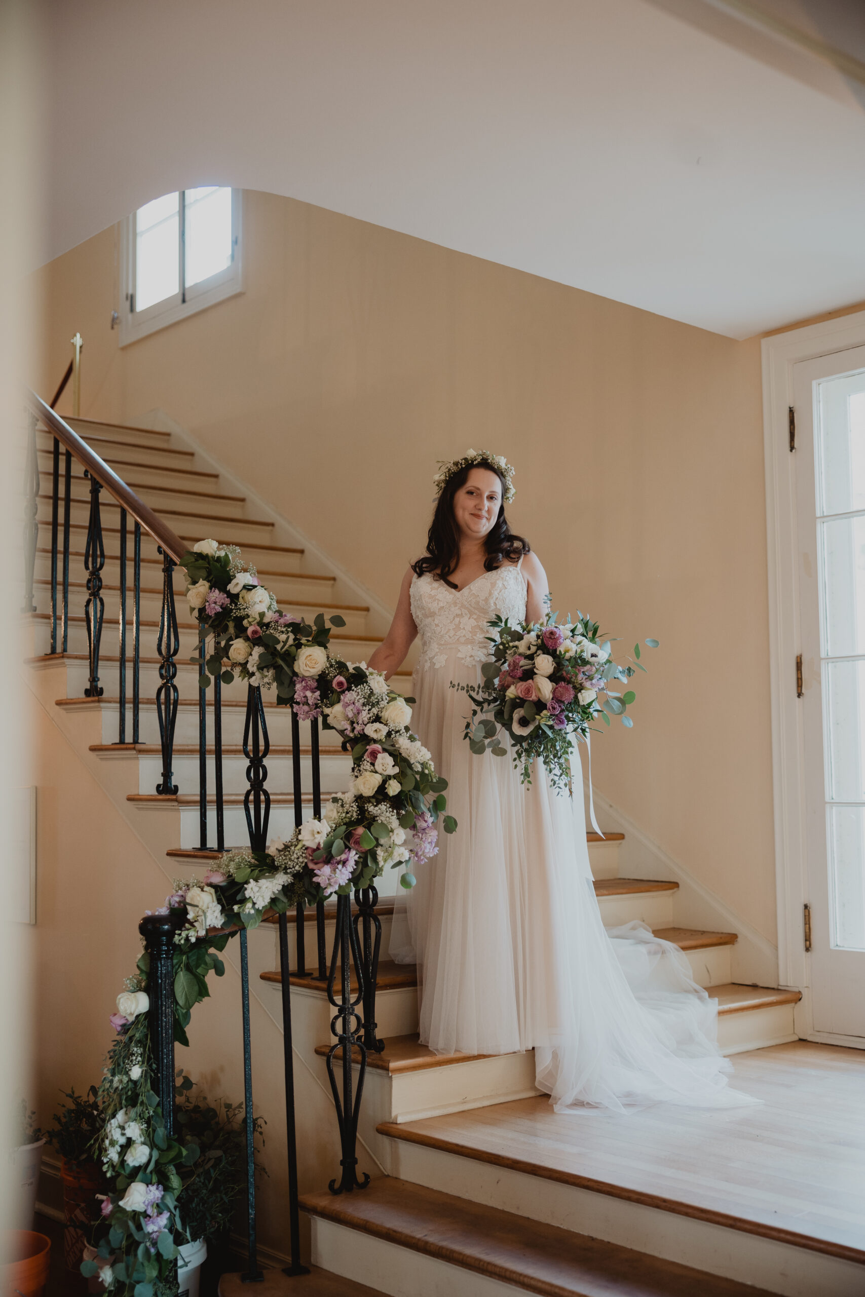 bride in lace and tulle gown with flower crown and colorful bridal bouquet 