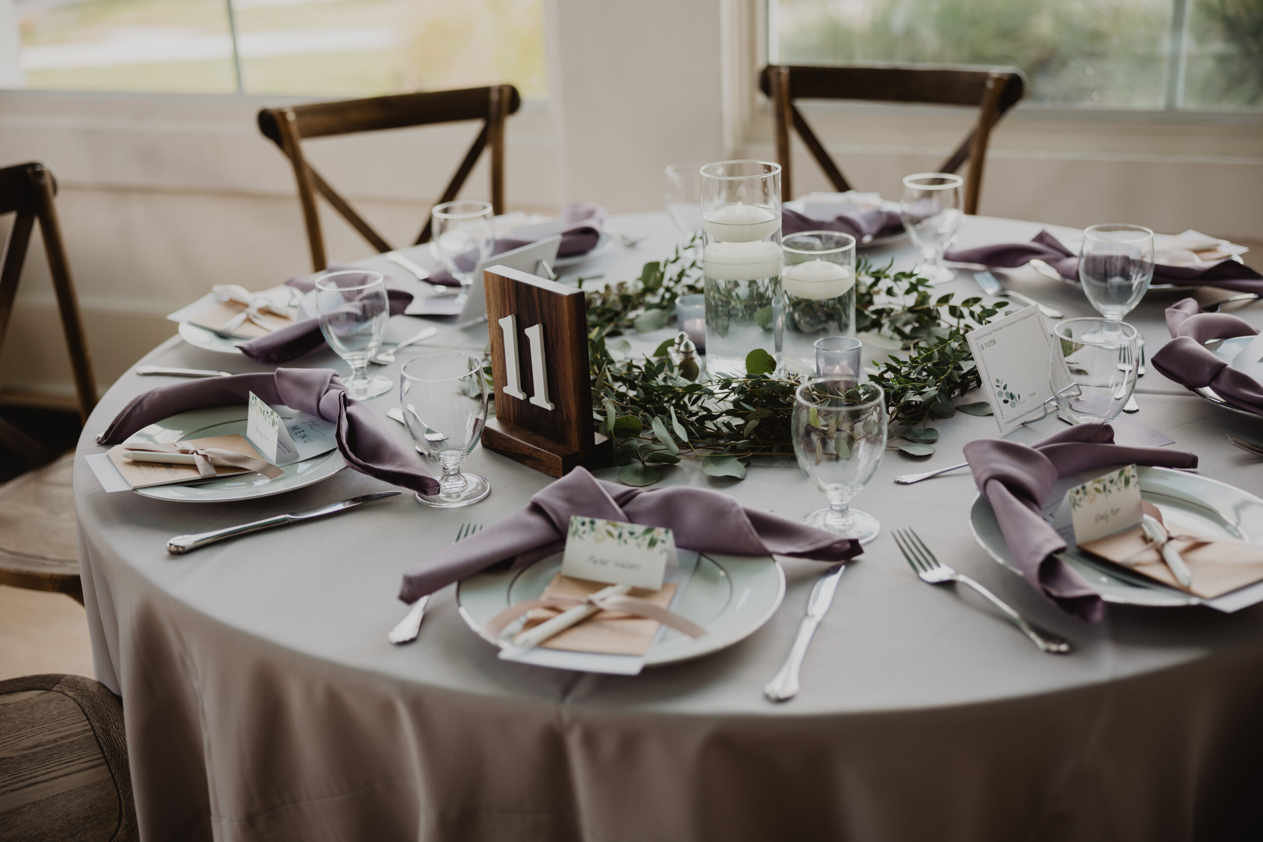 rustic wedding tablescape with floating candles and greenery centerpieces