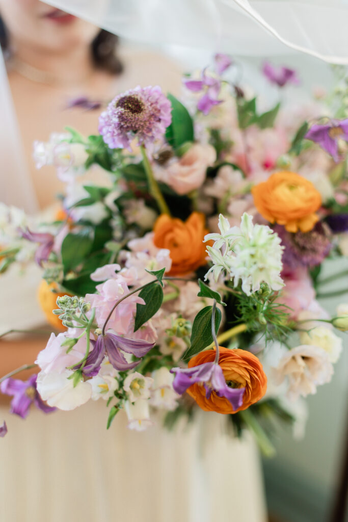 colorful bridal bouquet with orange and purple flowers