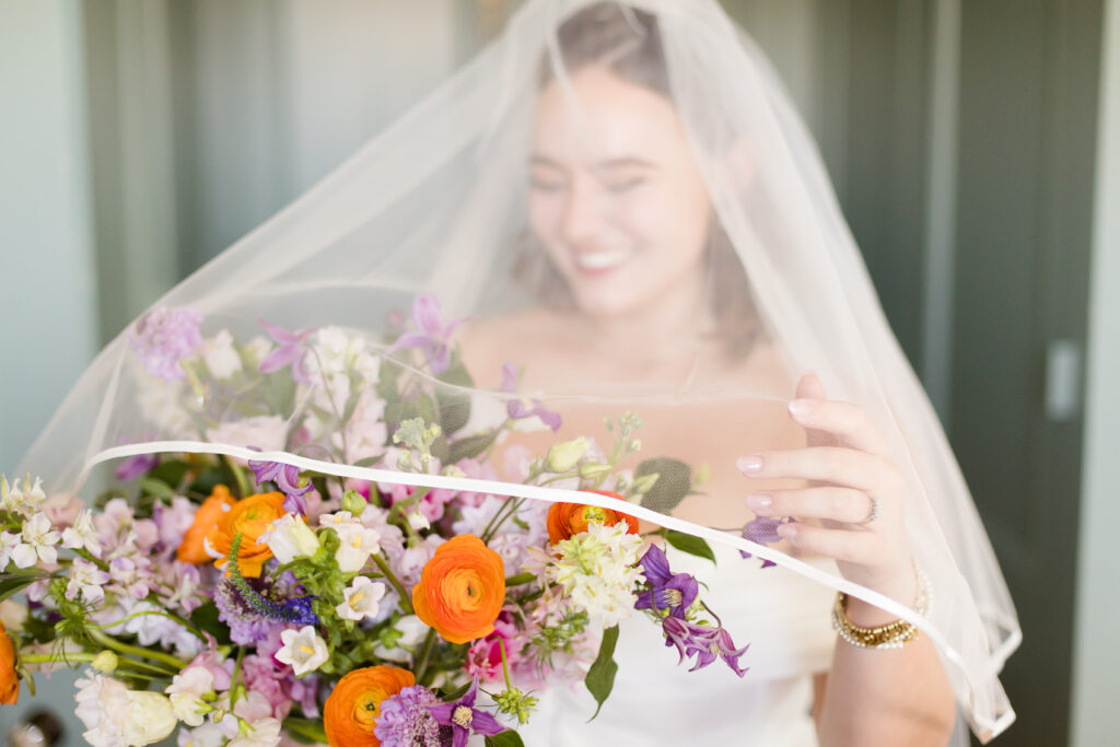 bride in veil with colorful bouquet