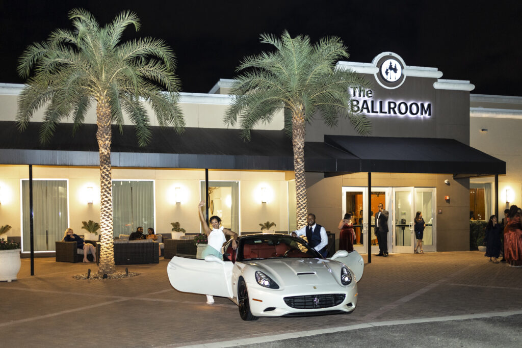 bride and groom exiting their wedding in classic car