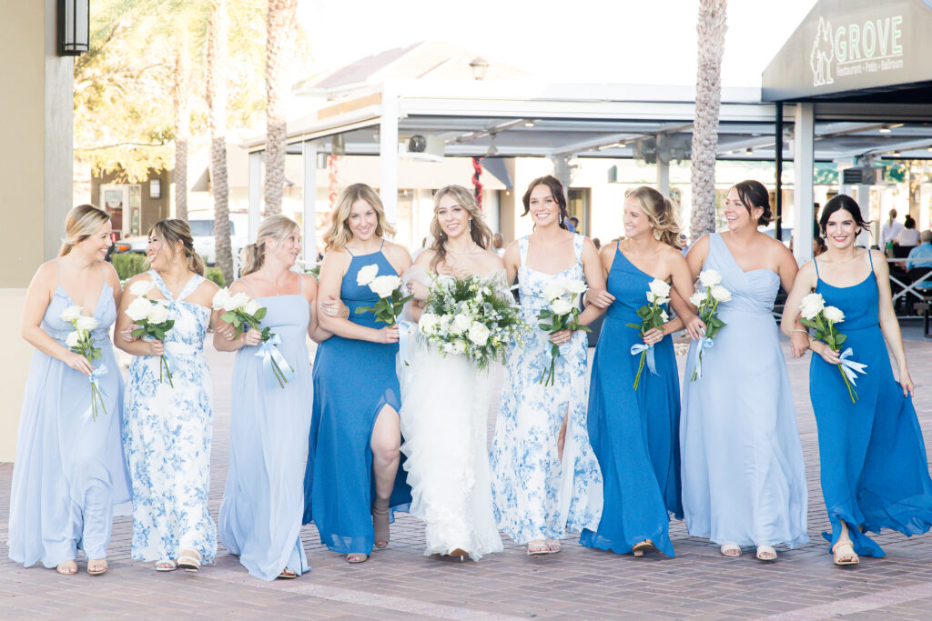 bridesmaids in different colored blue dresses