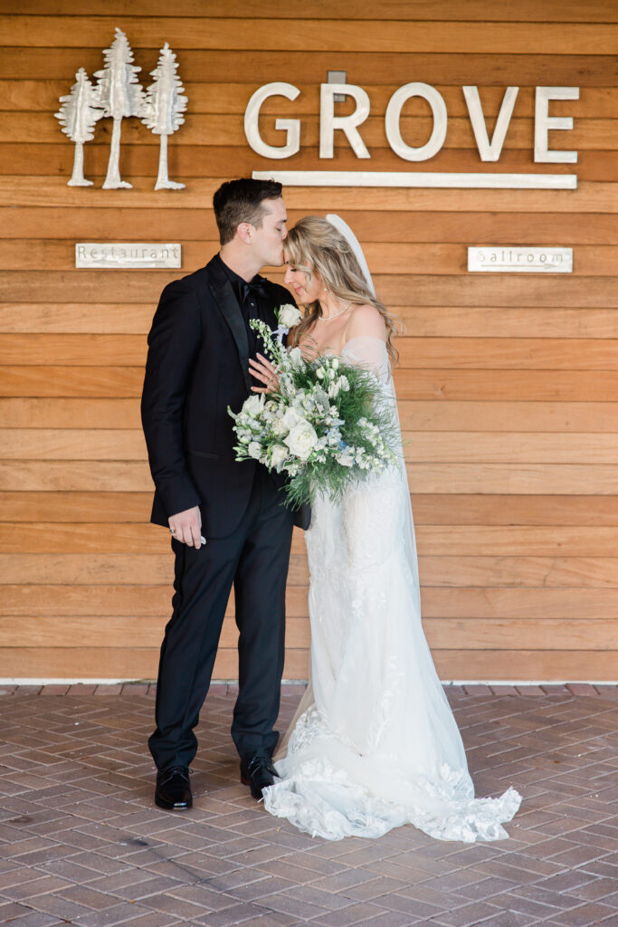 groom in black tux and bride in lace gown