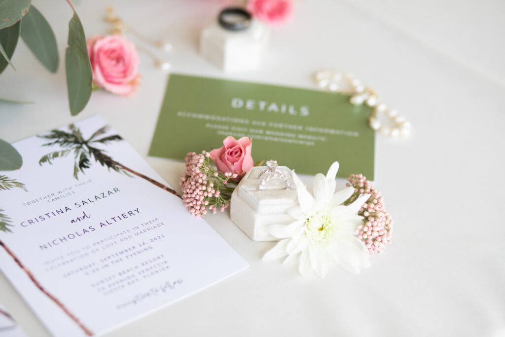 white and green wedding invitation flatlay with florals