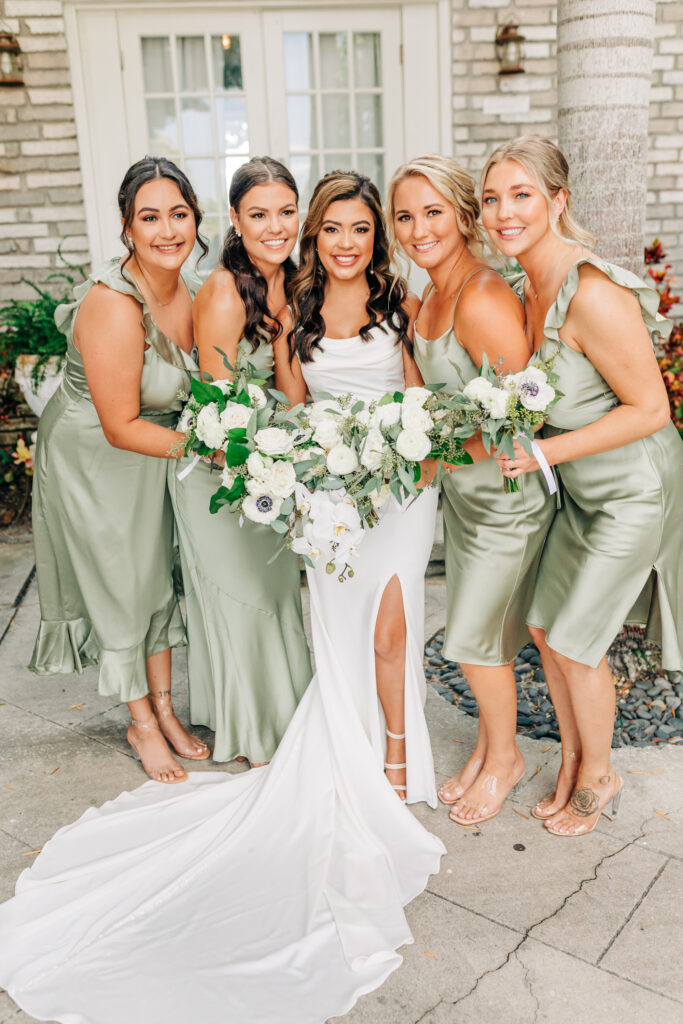 bridesmaids in green with green and white bouquets