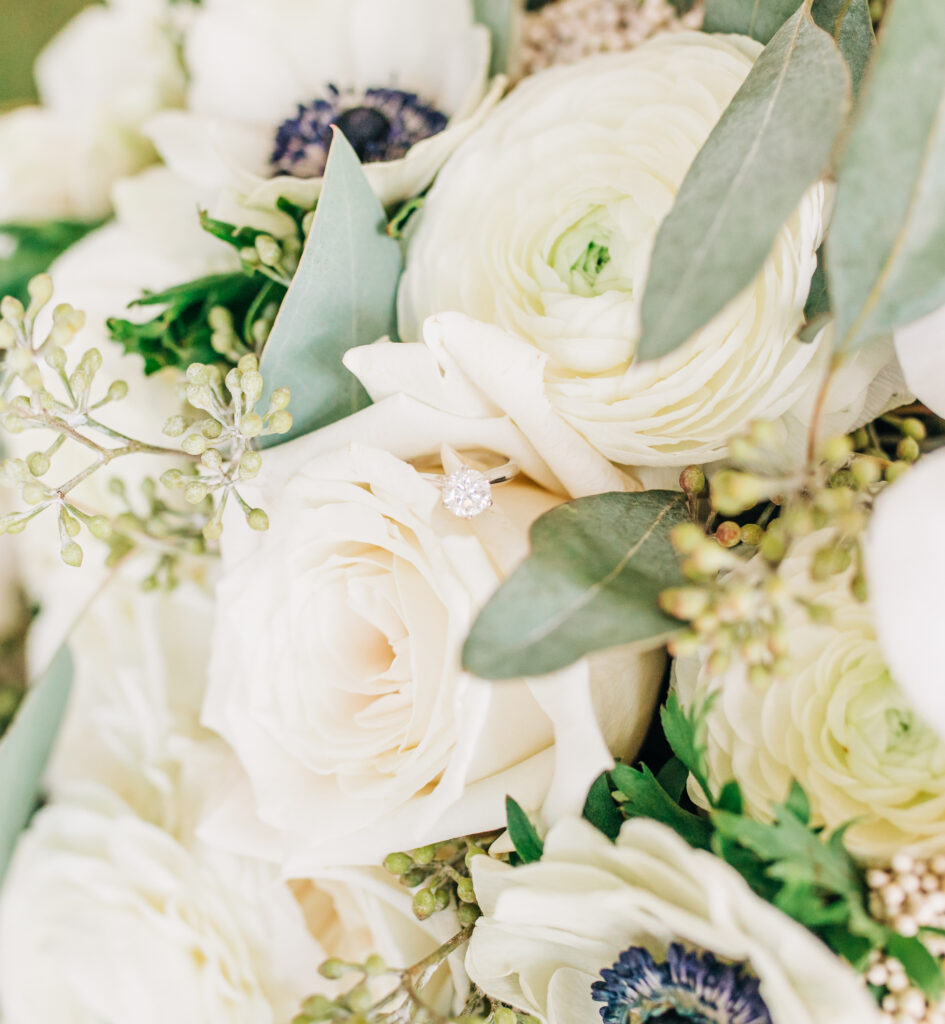 circular engagement ring in bridal bouquet