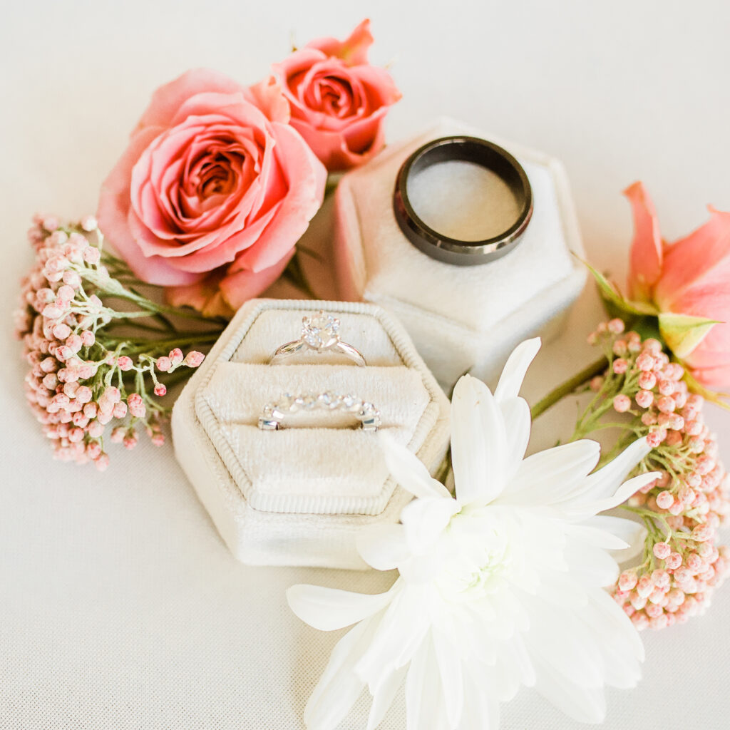 wedding ring flatlay with pink and white flowers