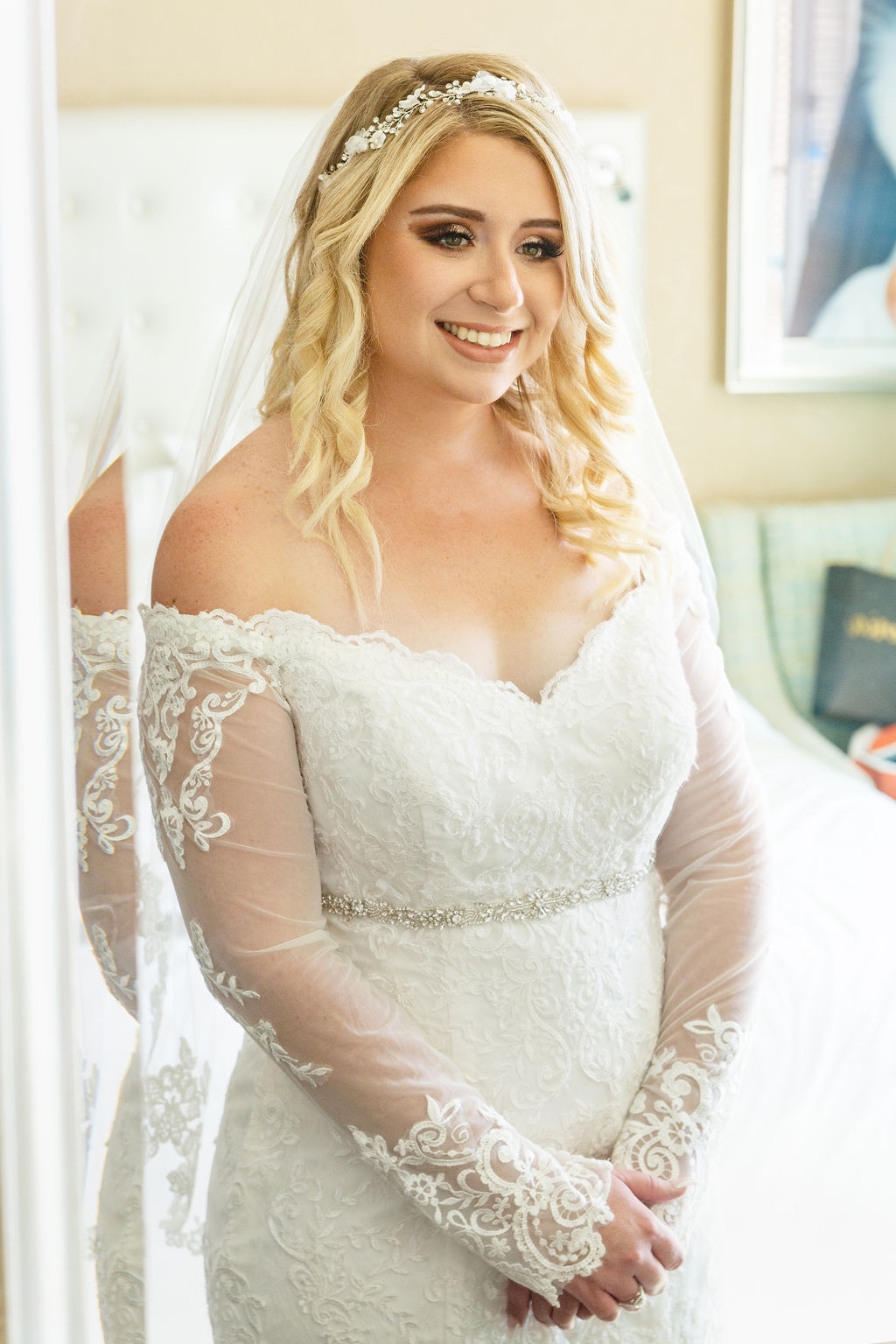 bride in off shoulder lace gown and white hairpiece