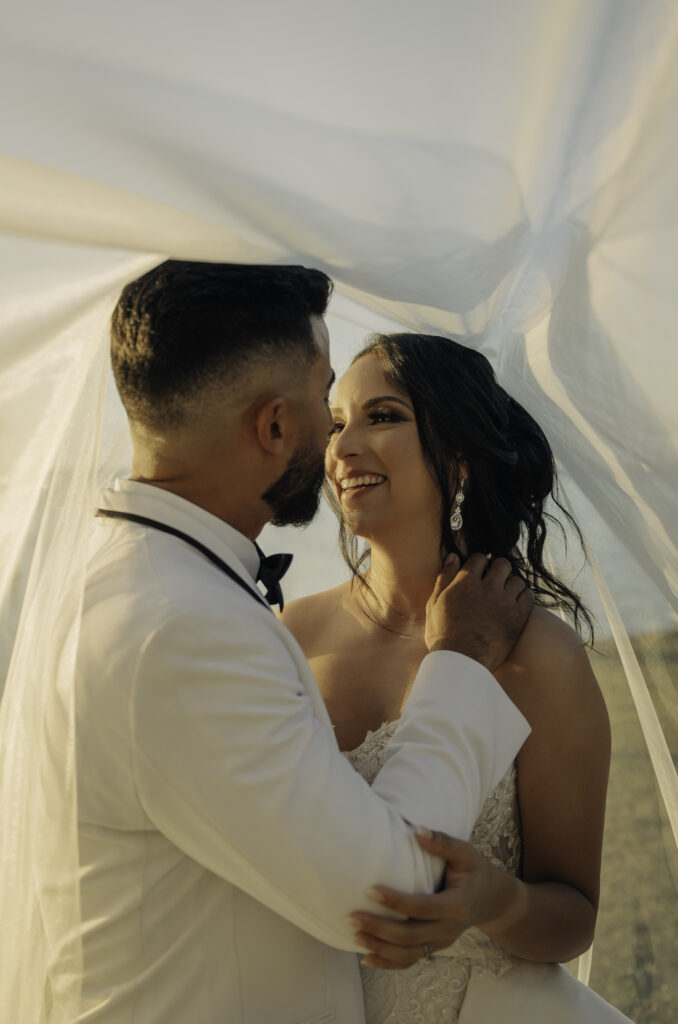 bride and groom portraits with veil 