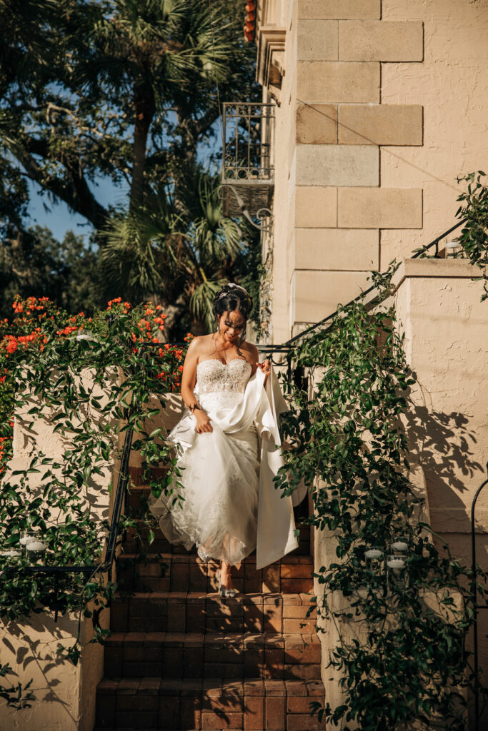 bride coming down the ivy covered stairs at Powel Crosley Estate