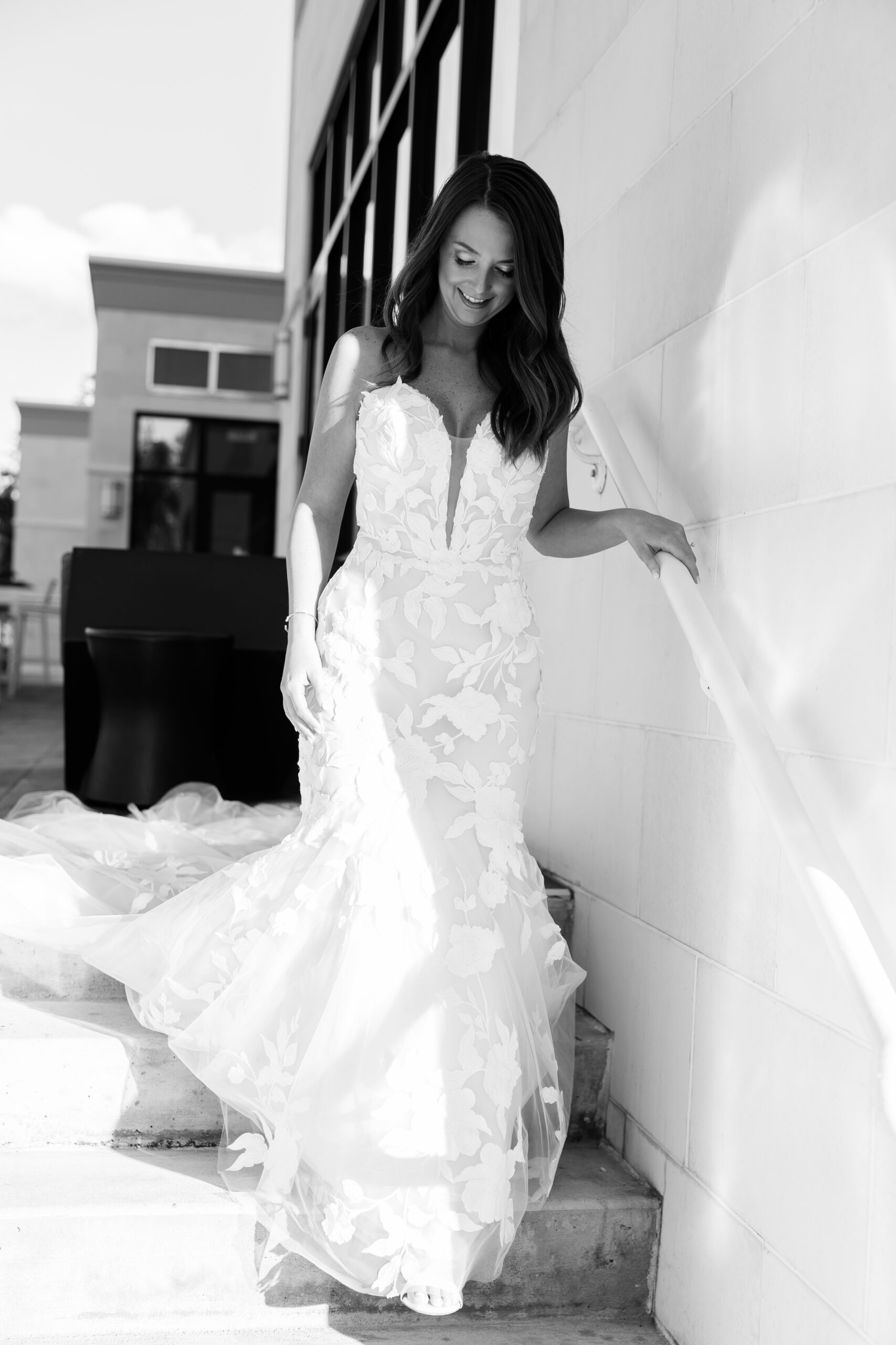 bride in fit and flare wedding gown with floral lace accents