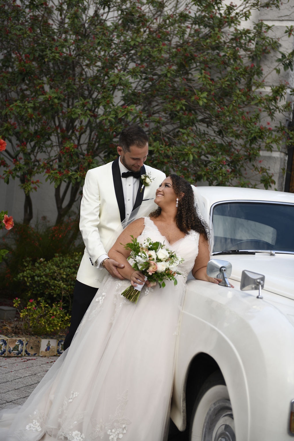 bride and groom with classic car outside Bishop Museum of Science