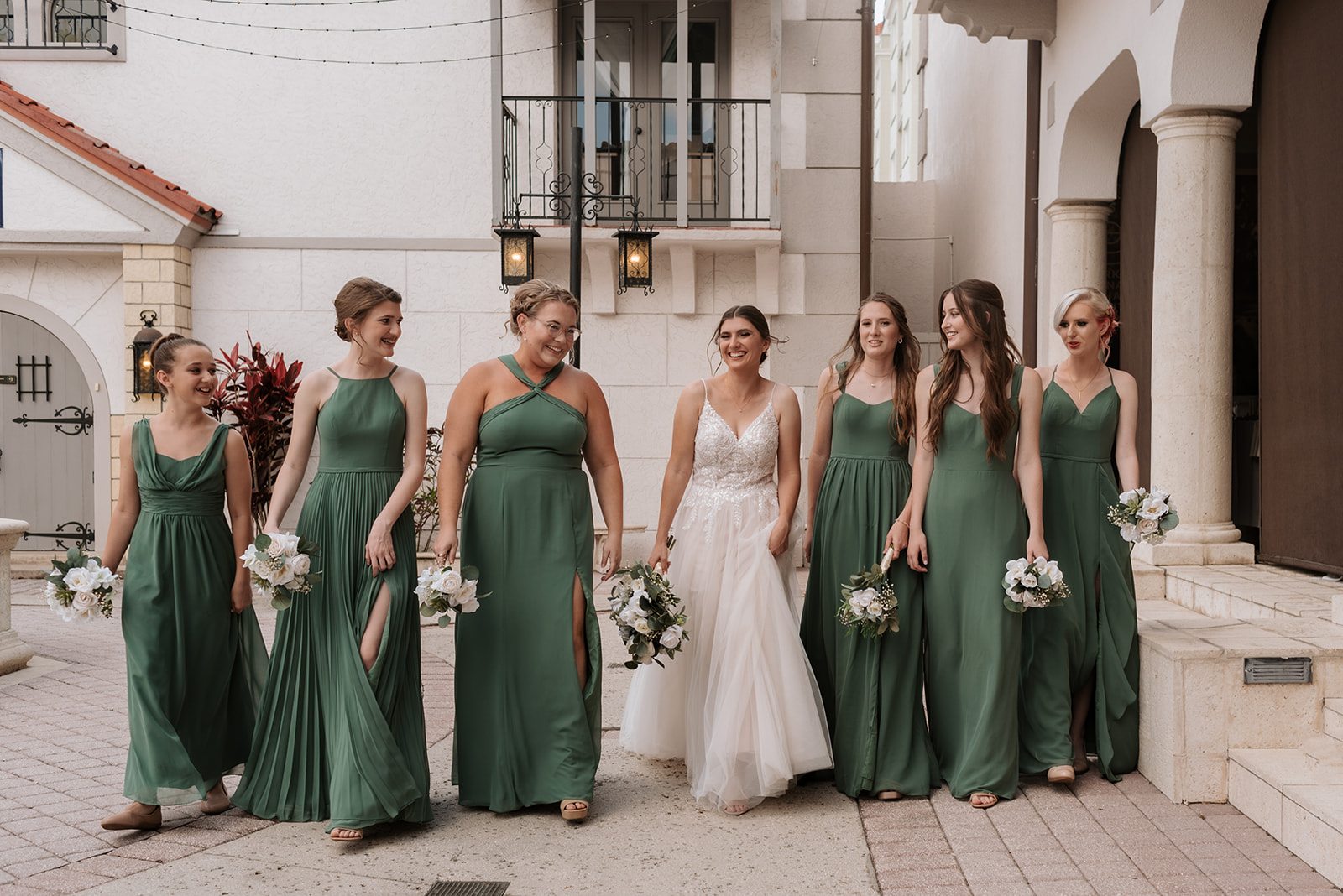 bridesmaids in mismatched green gowns