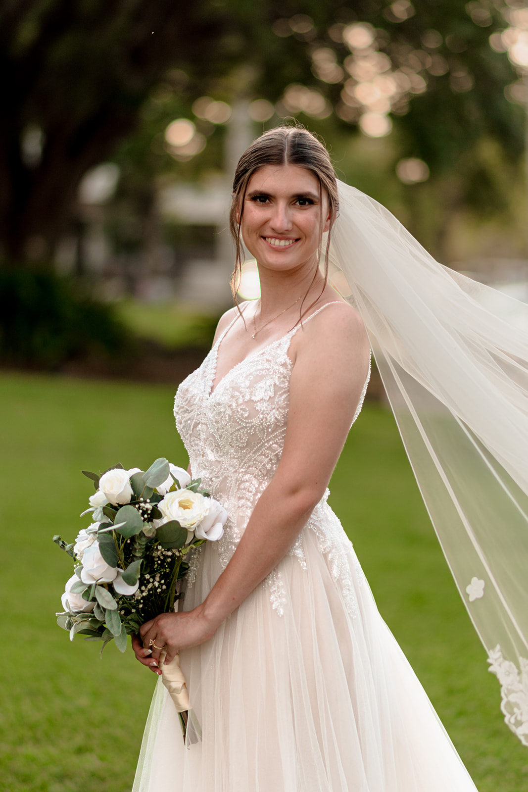 bride in embroidered tulle gown in classic updo