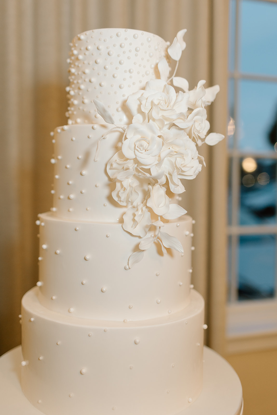 classic white wedding cake with floral deocrations