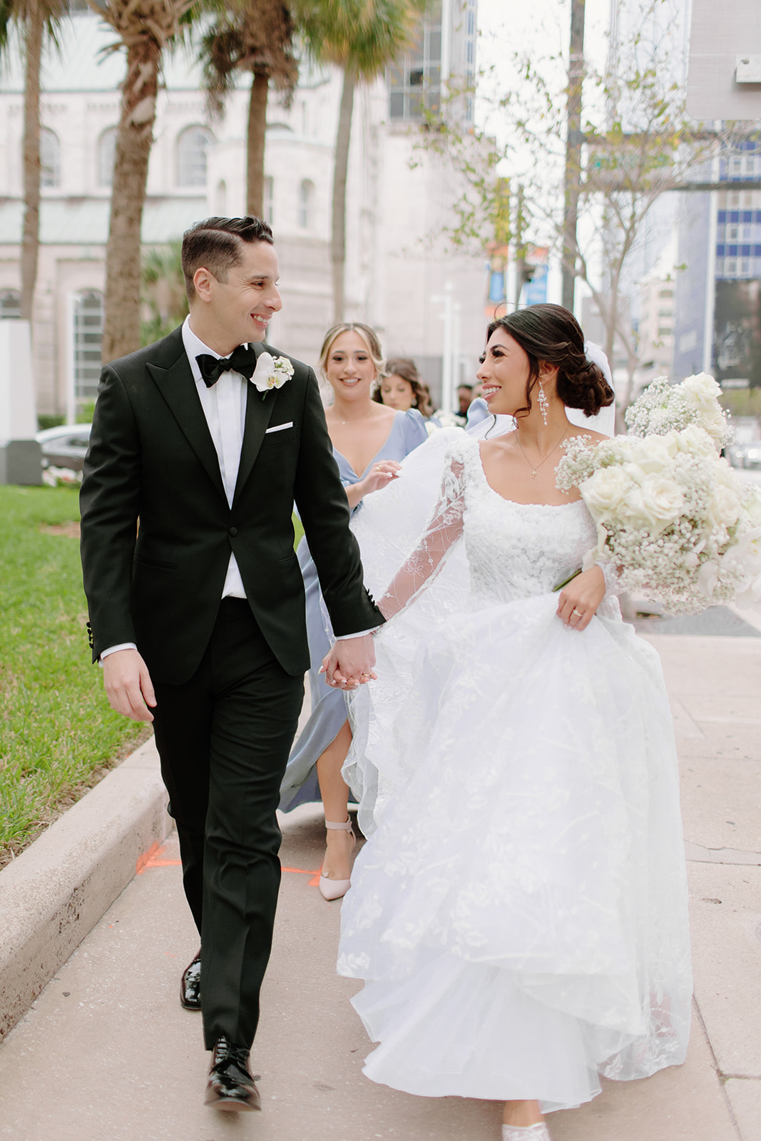 groom in black tux and bride in lace and tulle gown