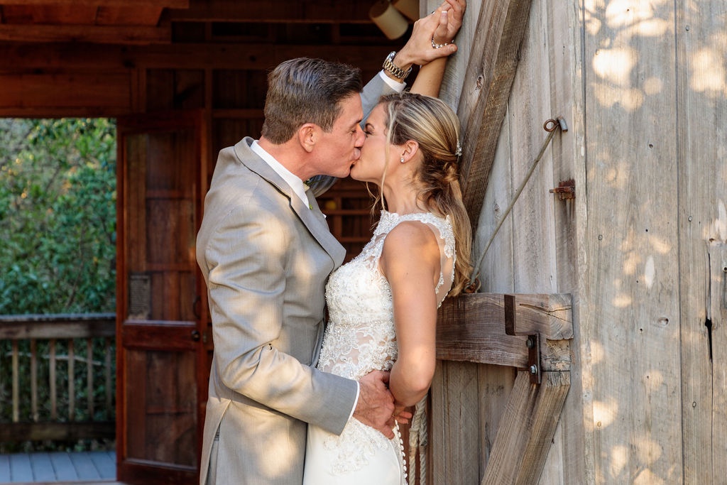 groom in light gray suit and bride in embroidered wedding gown