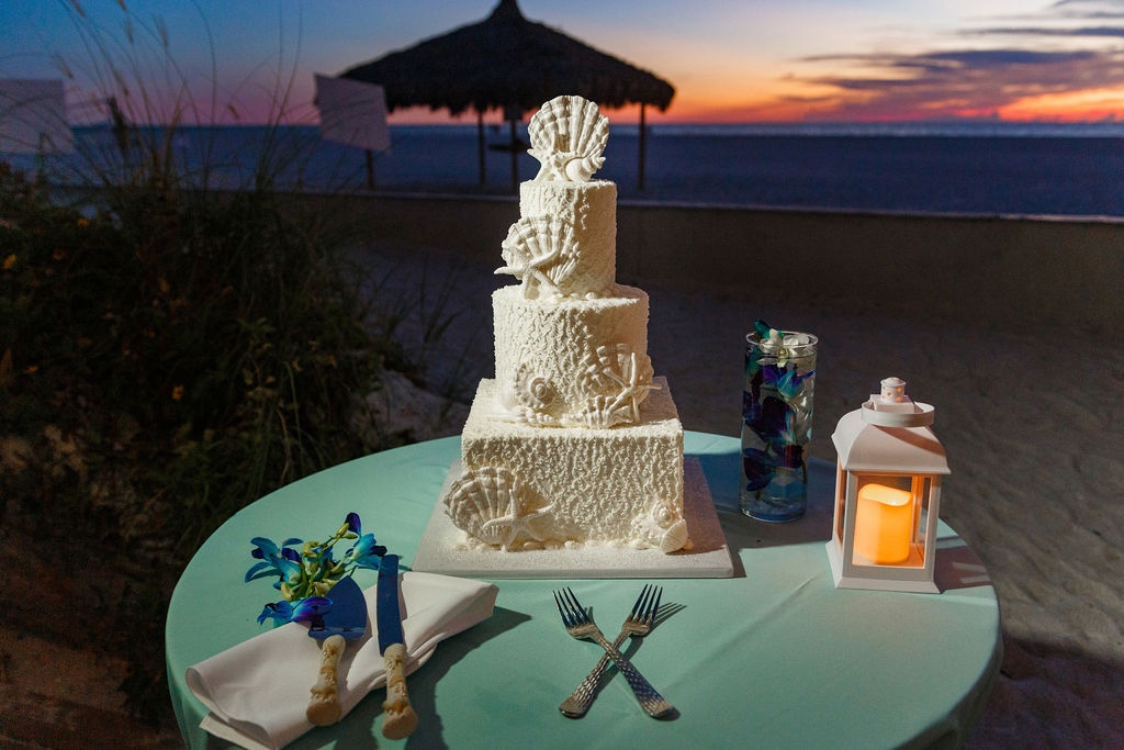 white wedding cake with sea shell details