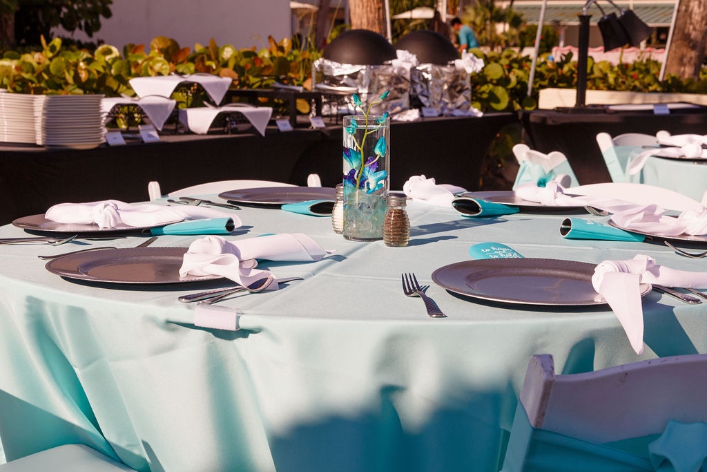 blue tablescape with silver chargers for Sandcastle Resort wedding by Precious Moments Events