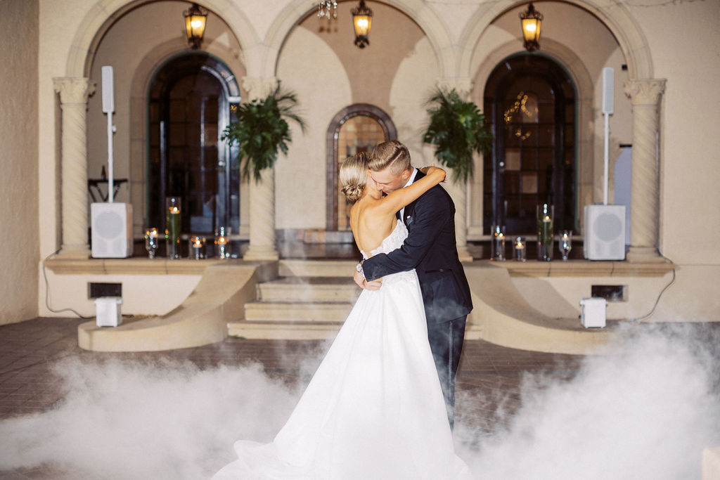 bride and groom first dance with smoke